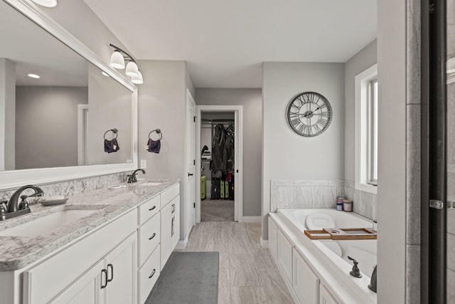 bathroom featuring vanity and a tub to relax in