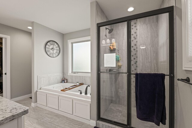 bathroom featuring vanity and separate shower and tub