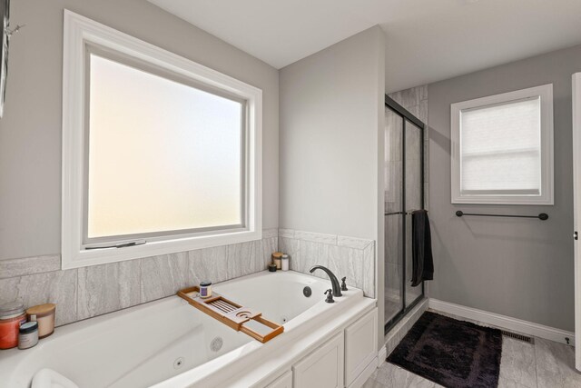 bathroom featuring plus walk in shower