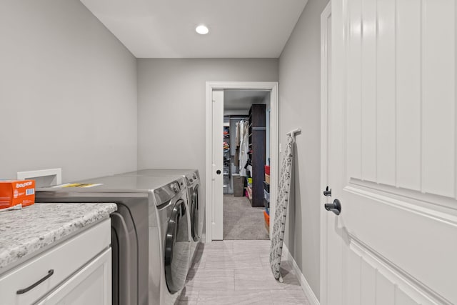 laundry area with light carpet and washing machine and dryer