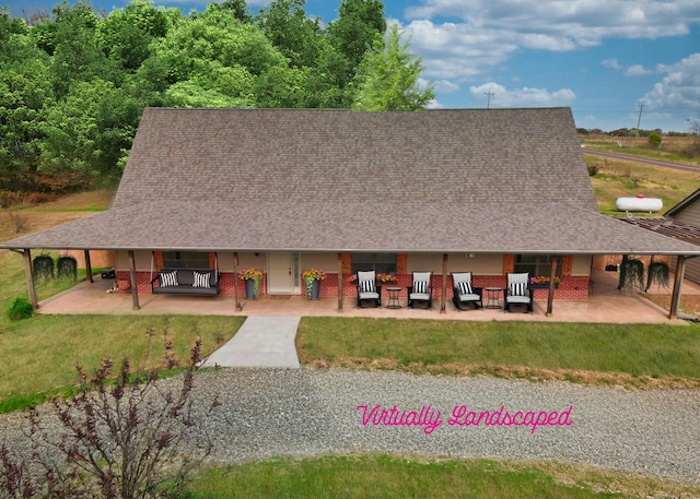 view of front of house featuring a front yard and a patio