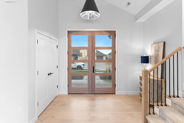 doorway to outside with vaulted ceiling, light hardwood / wood-style flooring, and french doors