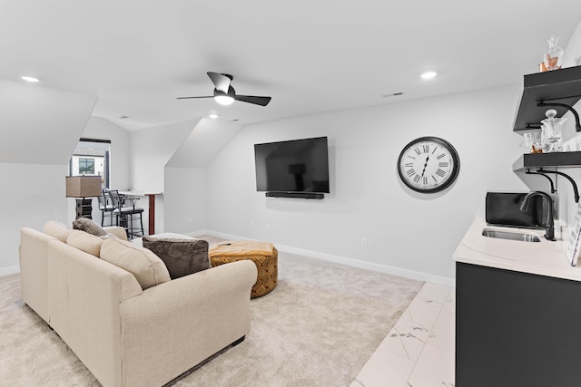 living area with lofted ceiling, marble finish floor, baseboards, and recessed lighting