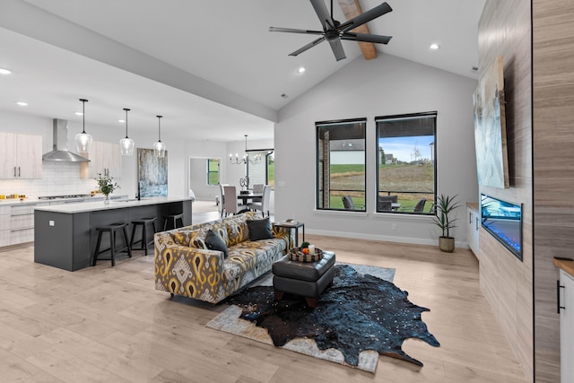 living room with high vaulted ceiling, beamed ceiling, light wood-style flooring, and baseboards