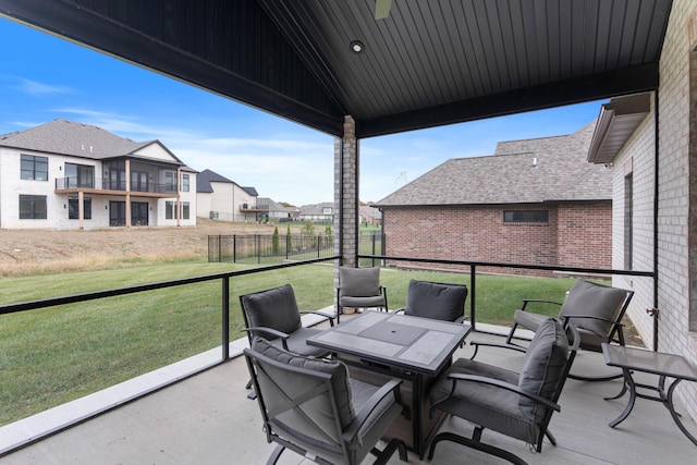 exterior space featuring a residential view, fence, and outdoor dining space