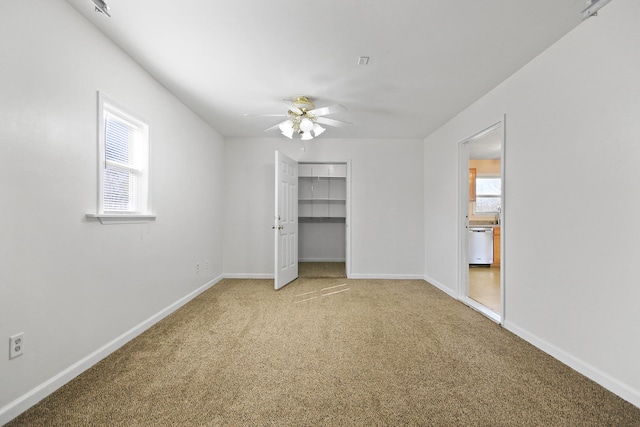 unfurnished bedroom with a closet, a ceiling fan, baseboards, and carpet floors