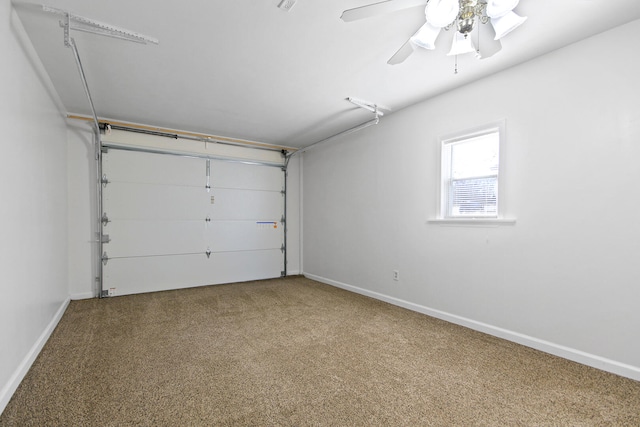 garage featuring baseboards and ceiling fan