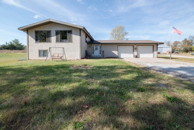 view of front of property featuring a garage and a front lawn