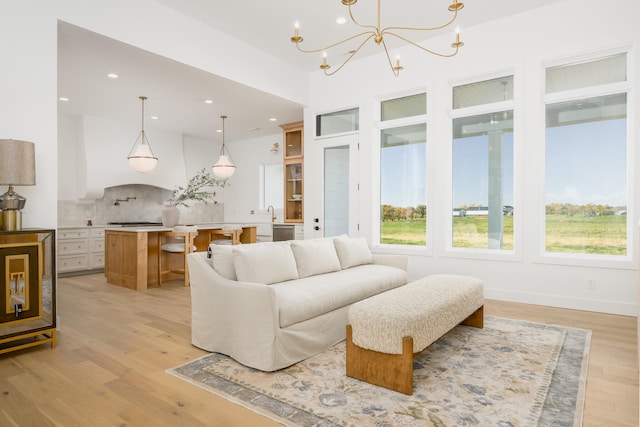 living room featuring light hardwood / wood-style floors and a notable chandelier