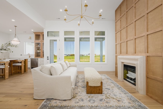 living room featuring light hardwood / wood-style floors and an inviting chandelier