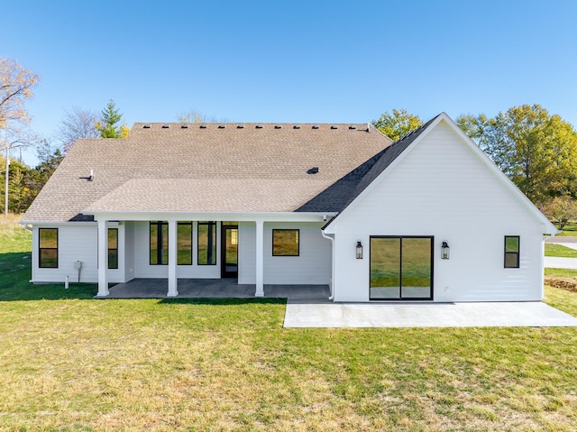 back of property with a patio area and a yard