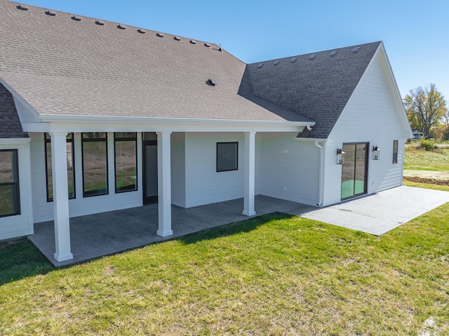 back of property featuring a patio and a lawn