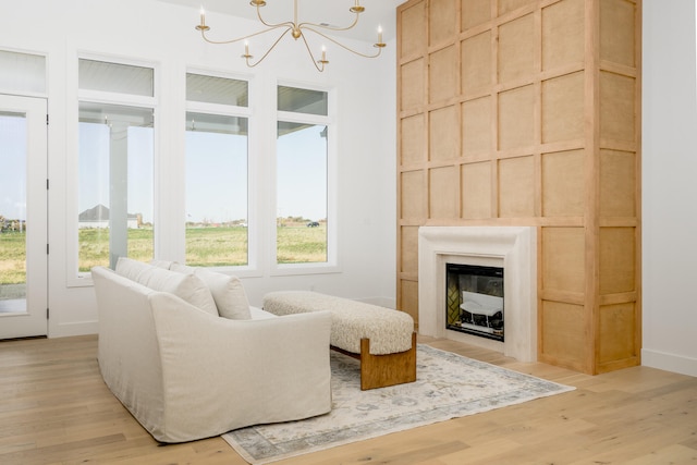 living area featuring light hardwood / wood-style floors and an inviting chandelier