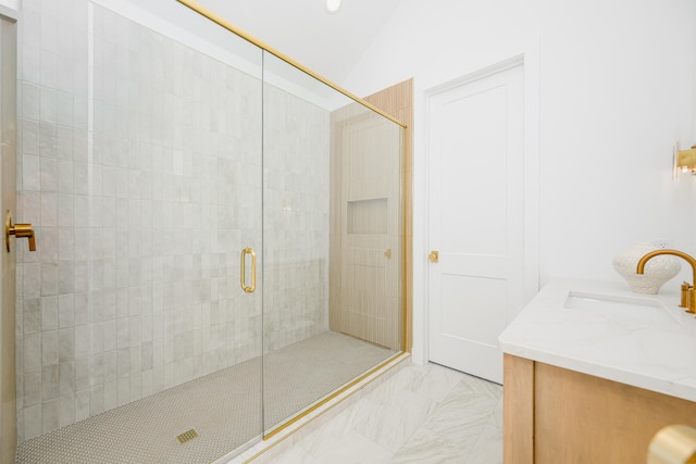 bathroom featuring vanity, a shower with shower door, and vaulted ceiling