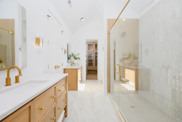 bathroom with vanity, a shower with door, and vaulted ceiling