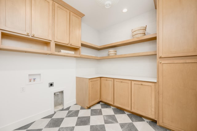 washroom with electric dryer hookup, washer hookup, and cabinets