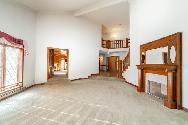 unfurnished living room with high vaulted ceiling, light carpet, and a fireplace