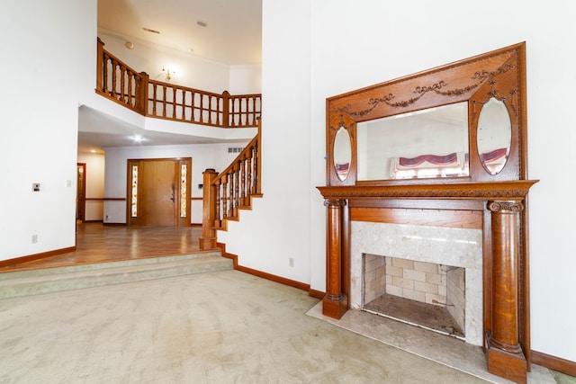 unfurnished living room featuring carpet floors and a fireplace