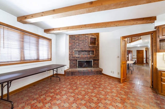 living room with beamed ceiling and a fireplace