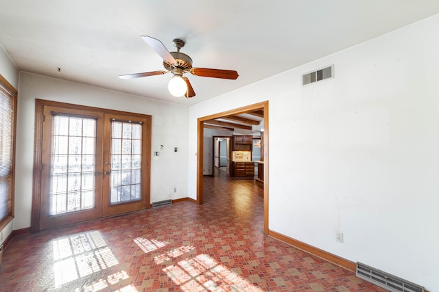 empty room featuring french doors and ceiling fan