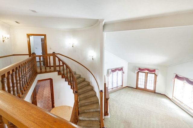 stairway featuring crown molding, carpet floors, and french doors