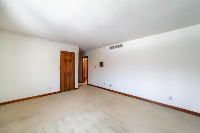 empty room featuring light carpet