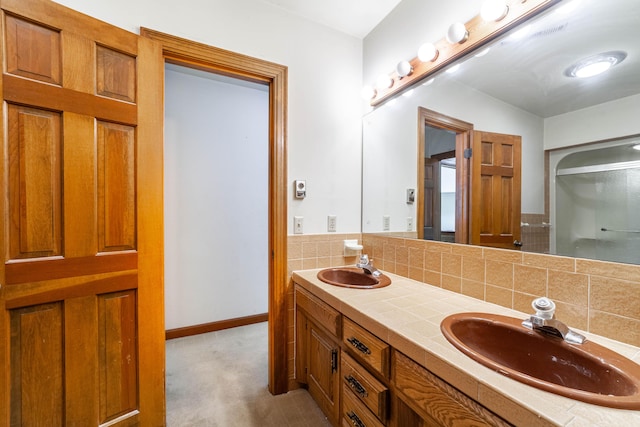 bathroom featuring vanity and backsplash