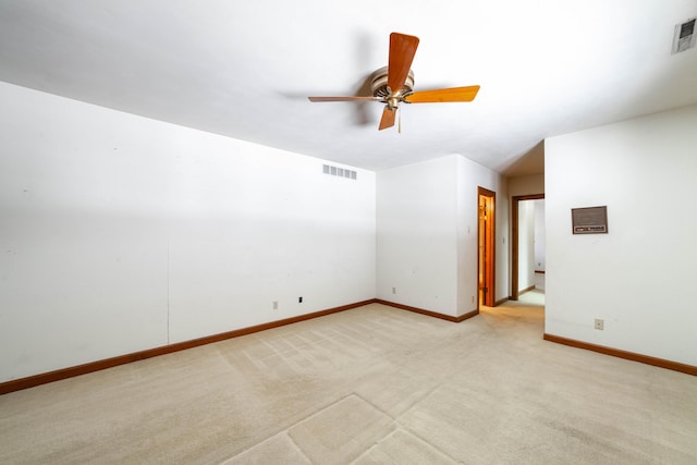 unfurnished room with light colored carpet and ceiling fan