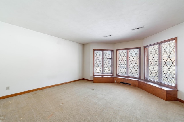 carpeted spare room featuring a healthy amount of sunlight