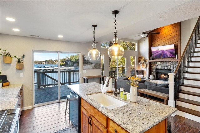 kitchen featuring pendant lighting, a center island, sink, dark hardwood / wood-style floors, and stainless steel appliances