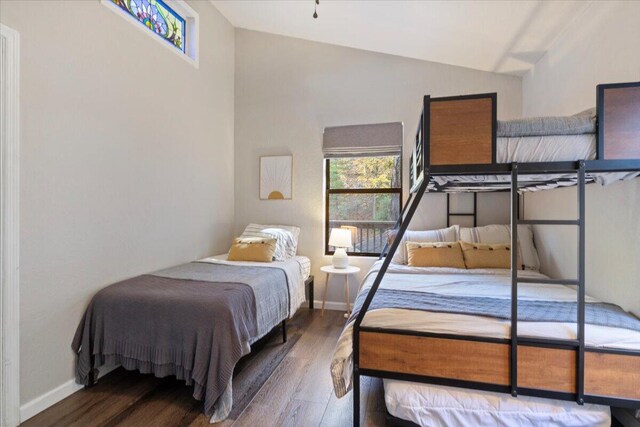 bedroom featuring wood-type flooring and vaulted ceiling