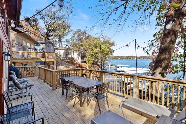 wooden terrace featuring a water view