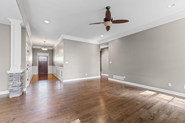 unfurnished living room featuring ornate columns, ornamental molding, and dark hardwood / wood-style floors