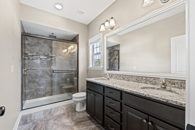 bathroom featuring an enclosed shower, vanity, and toilet