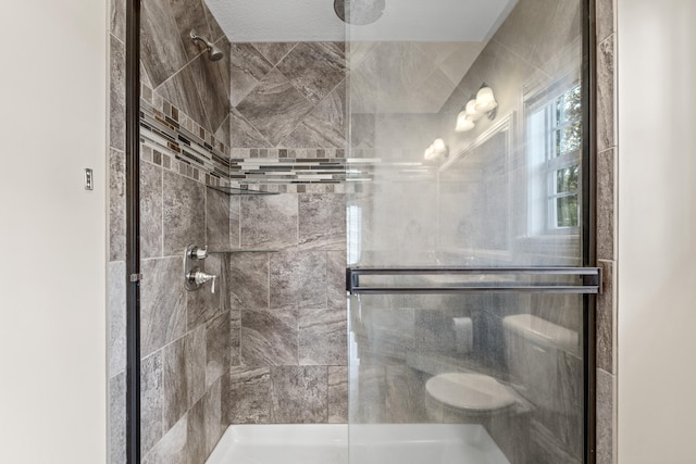 bathroom with a shower with shower door