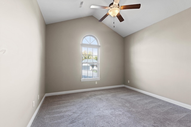 carpeted spare room with vaulted ceiling and ceiling fan