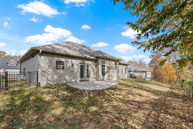 back of property with a lawn and a patio area