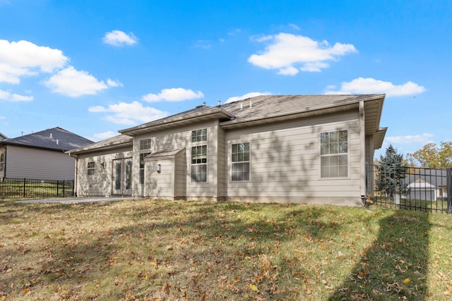 back of house featuring a patio and a yard