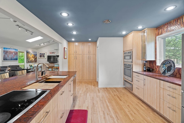 kitchen featuring light hardwood / wood-style flooring, black electric cooktop, sink, and light brown cabinets