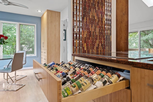 wine area with light hardwood / wood-style flooring and plenty of natural light