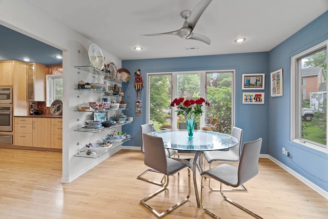 dining space featuring ceiling fan and light wood-type flooring