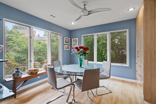 dining room featuring ceiling fan, light wood-type flooring, and a wealth of natural light