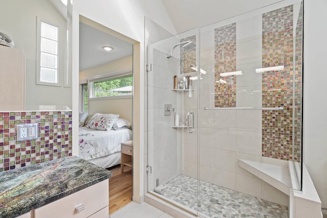 bathroom featuring vanity, wood-type flooring, lofted ceiling, and an enclosed shower