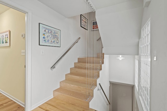 staircase featuring wood-type flooring