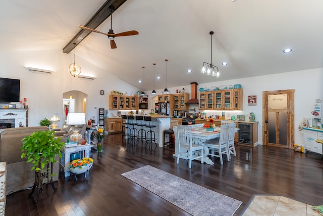 dining space featuring dark wood-type flooring, high vaulted ceiling, beamed ceiling, and beverage cooler