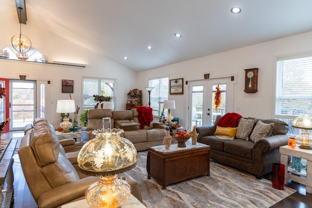 living room featuring french doors, a notable chandelier, wood-type flooring, and plenty of natural light