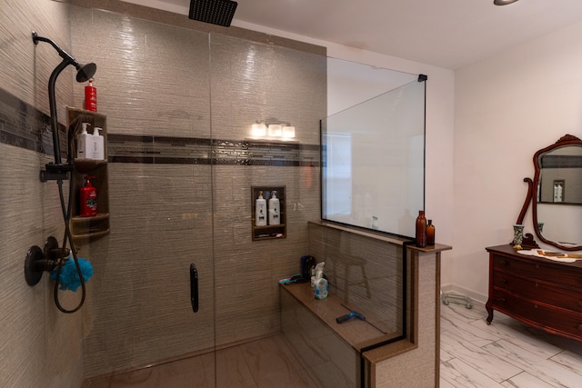 bathroom with vanity and a tile shower