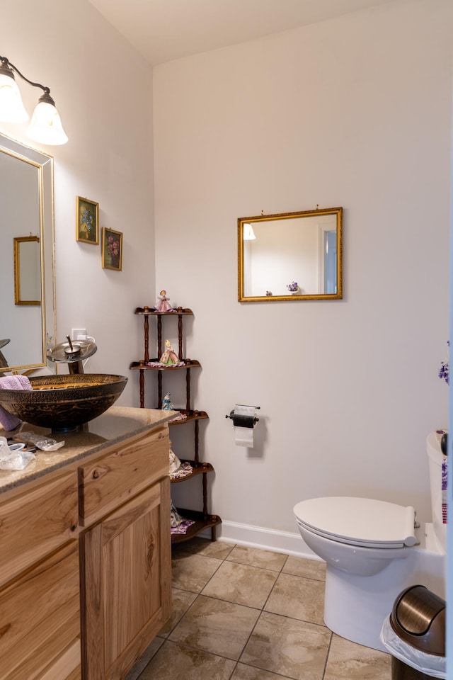 bathroom with vanity, toilet, and tile patterned floors