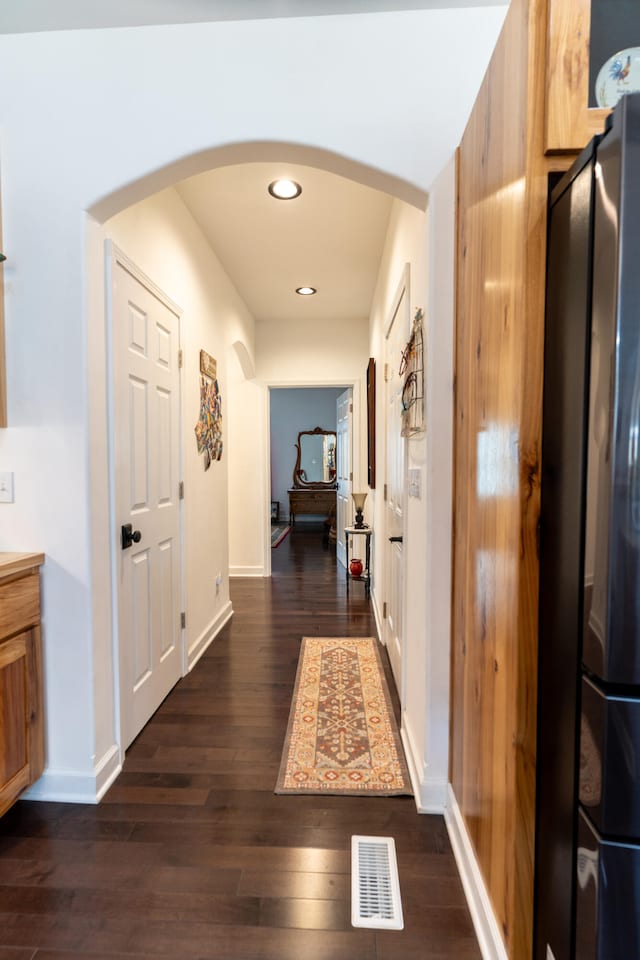 corridor featuring dark hardwood / wood-style floors