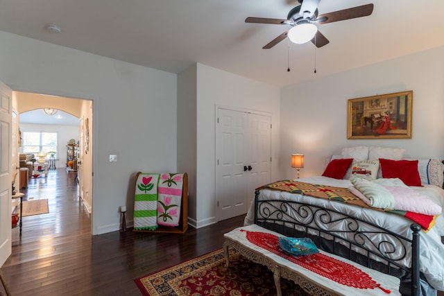 bedroom with ceiling fan, dark hardwood / wood-style flooring, and a closet